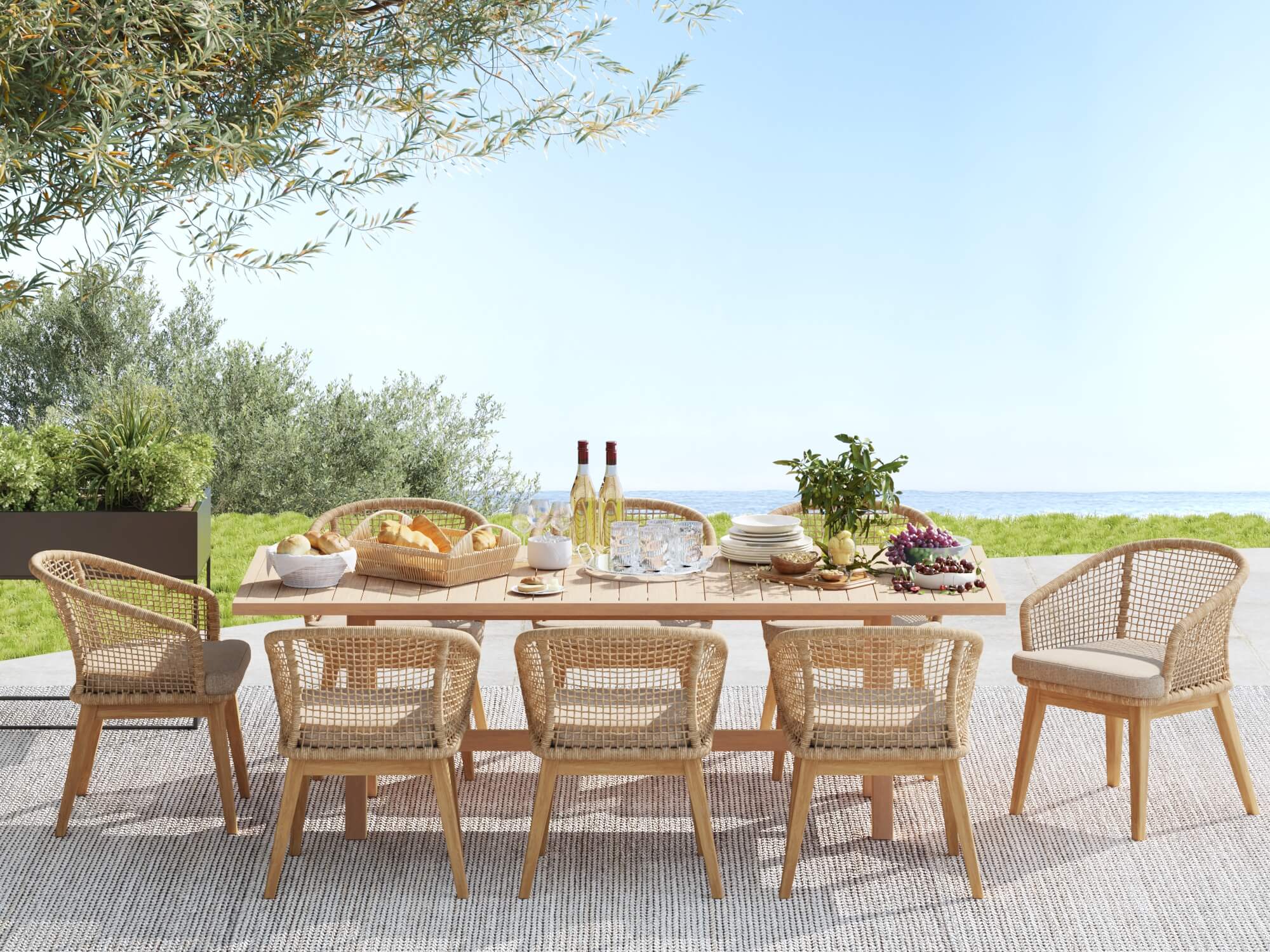 wooden Outdoor dining set for 8 with rope chairs and table, set for a meal with wine and food, on a patio with greenery and ocean view- Sunsitt Modern Premium Patio Outdoor Furniture