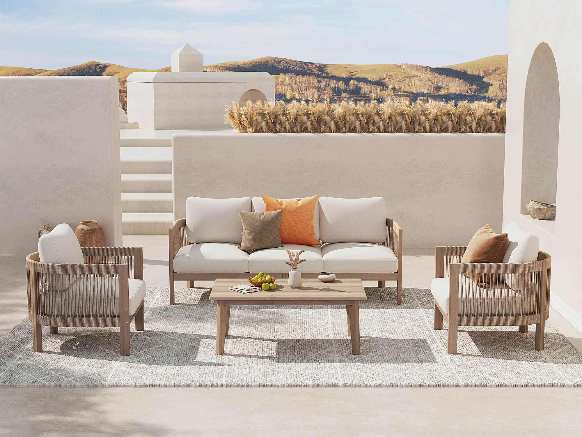 Outdoor patio set with wooden furniture and cushions on a terrace with a scenic background.