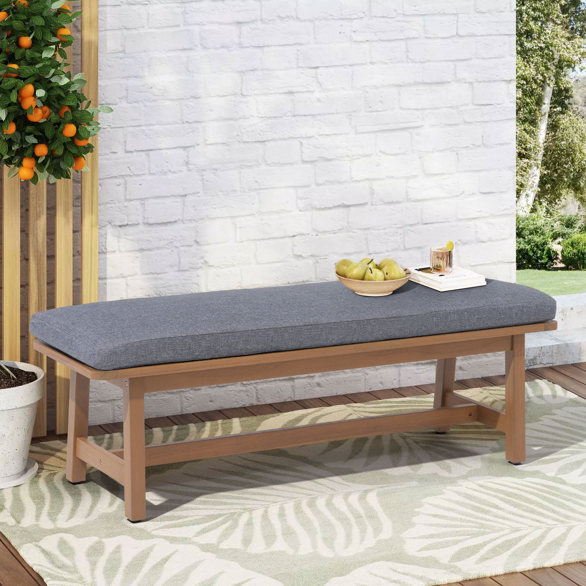 Wooden bench with a gray cushion on a patio- Sunsitt Modern Premium Patio Outdoor Furniture
